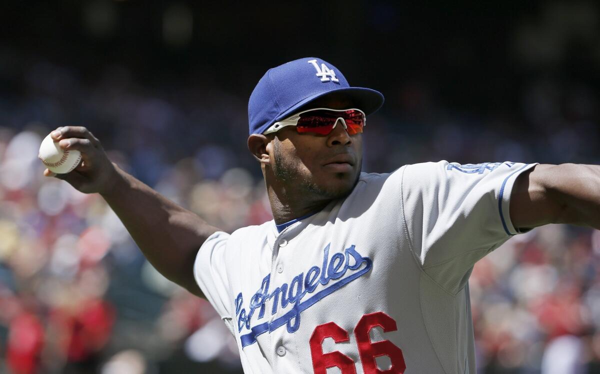 Dodgers' Yasiel Puig warms up prior to a game against Arizona on Sunday.