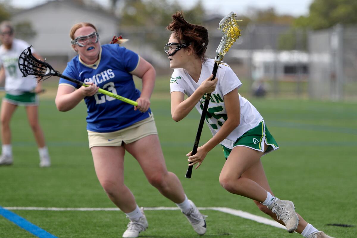 Edison's Gwen Ontiveros, right, drives the ball against Santa Margarita's Katie Eli, left.