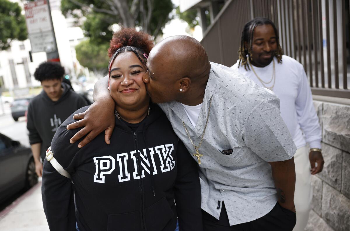 Jofama Coleman kisses his 19-year-old daughter Jocelyne after he was exonerated.