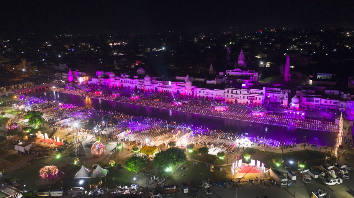 An illuminated city of Ayodhya is seen on the eve of a groundbreaking ceremony of a temple dedicated to the Hindu god Ram in Ayodhya, India, Tuesday, Aug. 4, 2020. Wednesday's groundbreaking ceremony follows a ruling by India's Supreme Court last November favoring the building of a Hindu temple on the disputed site in Uttar Pradesh state. Hindus believe their god Ram was born at the site and claim that the Muslim Emperor Babur built a mosque on top of a temple there. The 16th century Babri Masjid mosque was destroyed by Hindu hard-liners in December 1992, sparking massive Hindu-Muslim violence that left some 2,000 people dead. (AP Photo/Rajesh Kumar Singh)