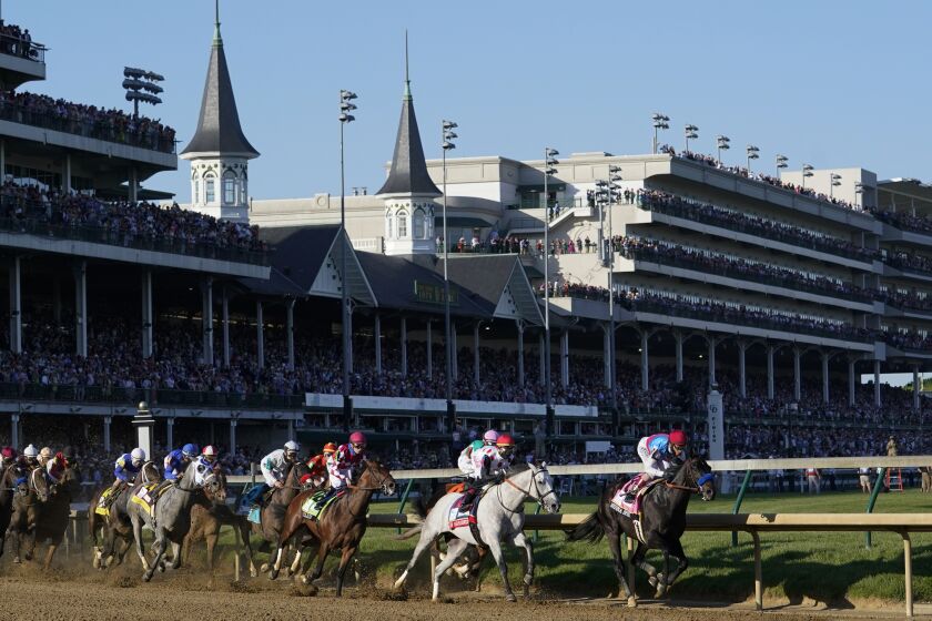 Medina Spirit leads the field around the first turn on the way to winning the Kentucky Derby