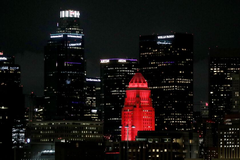 LOS ANGELES, CALIF. - DEC. 1, 2022. Los Angeles City Hall is bathed in red light to commemorate World AIDS Day on Thursday, Dec. 1, 2022. (Luis Sinco / Los Angeles Times)