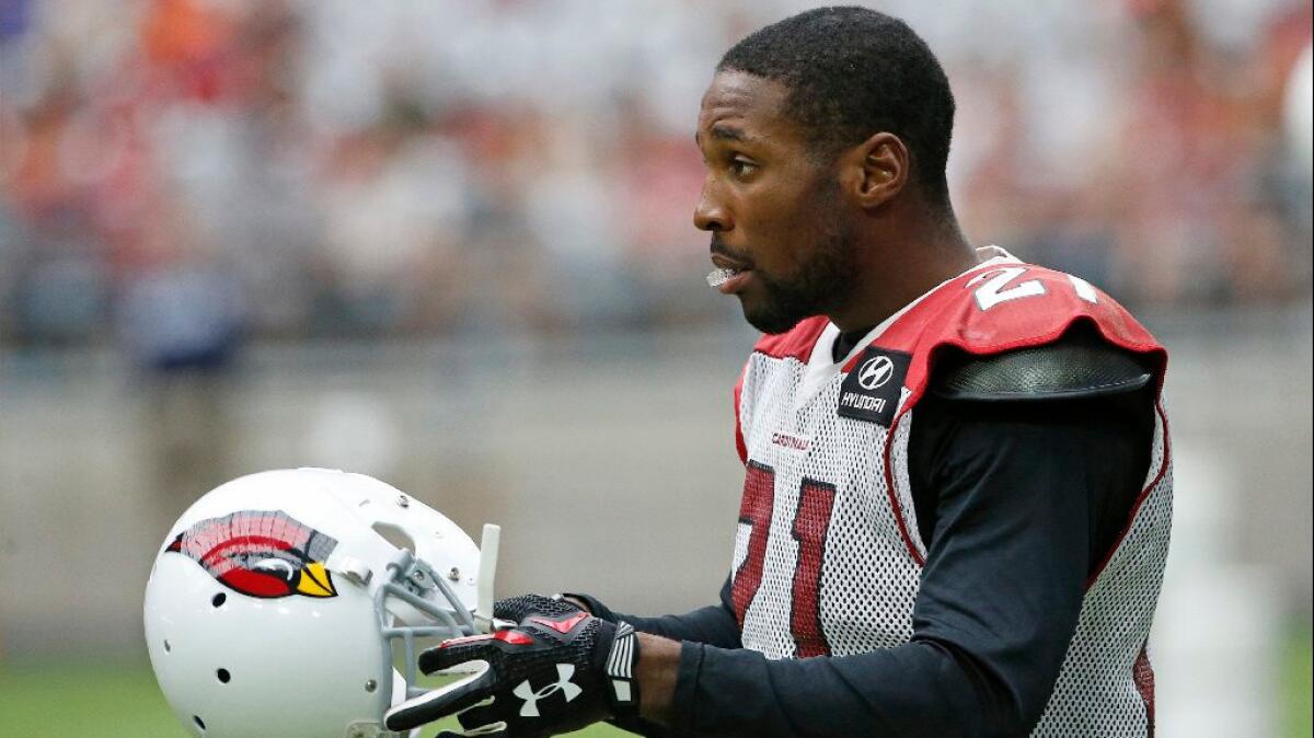 Cardinals cornerback Patrick Peterson puts on his helmet during a practice on Aug. 1.