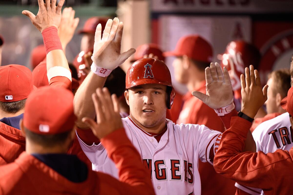 Angels outfielder Mike Trout is congratulated upon his return to the dugout after hitting a two-run home run in the fourth inning.