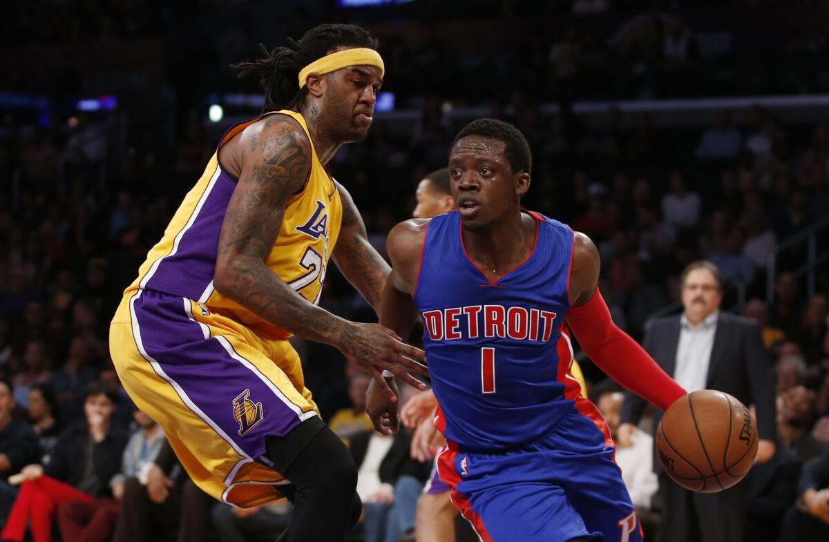 Detroit guard Reggie Jackson dribbles around Jordan Hill during the first half of a game Tuesday at Staples Center.