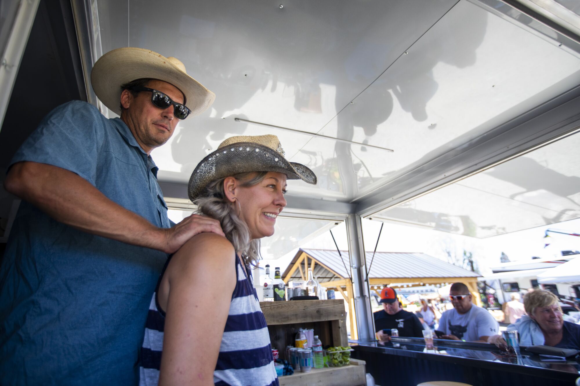 Kevin Goss, left, and his girlfriend Kira, right, operate a mobile bar during the Gold Digger Days celebration