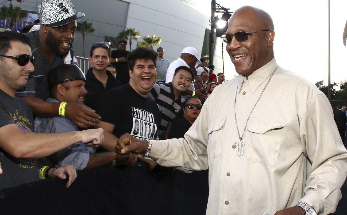 Tommy 'Tiny' Lister fist-bumps a fan as people line the red carpet