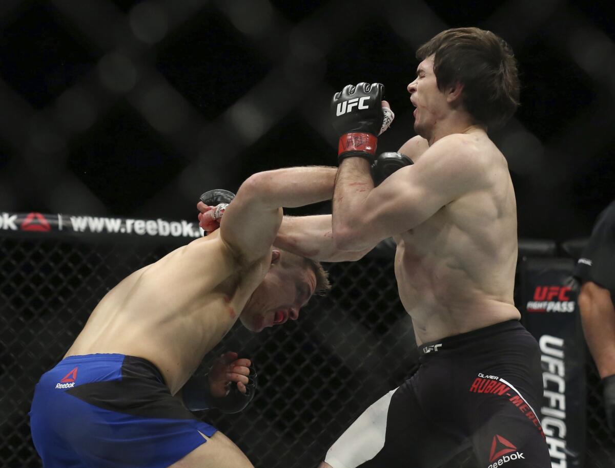 Drew Dober, left, and Olivier Aubin-Mercier trade blows during their bout on Saturday in Toronto.