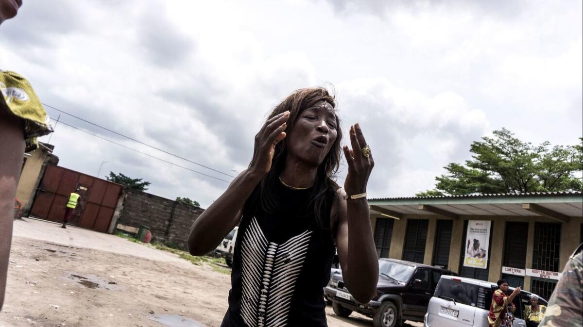 A Congolese woman mourns the death of a man who was killed when police opened fire on protesters at a Catholic church in Kinshasa on Feb. 25.