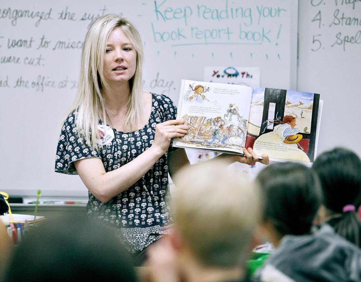 KFI radio producer Mystie Heckler reads "Nine for California" to 4th graders at Roosevelt Elementary School in Burbank on Wednesday, March 27, 2013. Community leaders came out to the school to read to students and discuss how reading impacts their careers.