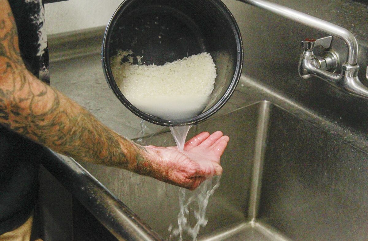 Chef Davin Waite washes rice at his Oceanside restaurant.