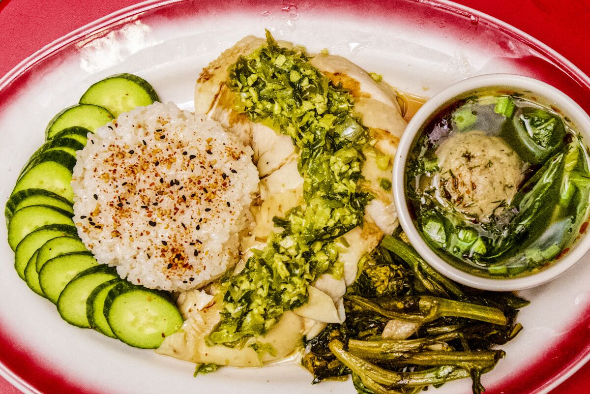An overhead photo of Oy Bar's Hainan-style chicken with a cup of matzo ball soup.
