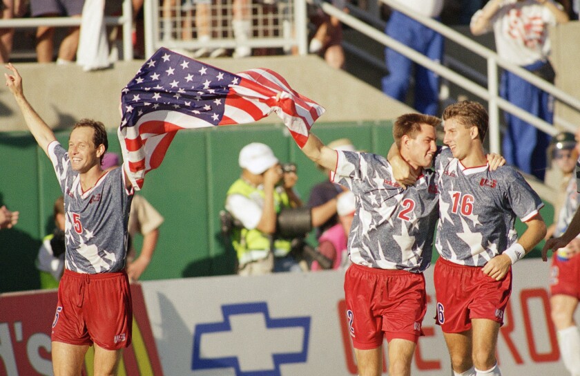 United States players Thomas Dooley, left, Mike Lapper, middle, and Mike Sorber celebrate their 2-1 upset victory.