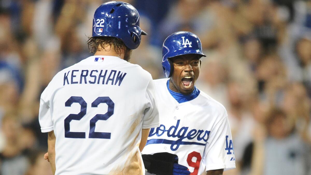 Dodgers teammates Clayton Kershaw, left, and Dee Gordon celebrate after scoring runs during the fifth inning of the team's 4-1 win over the Washington Nationals on Tuesday.