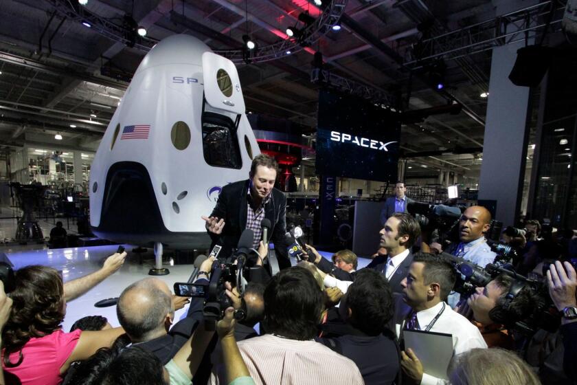 Elon Musk, CEO of SpaceX, introduces the company's Dragon spacecraft in Hawthorne in 2014.