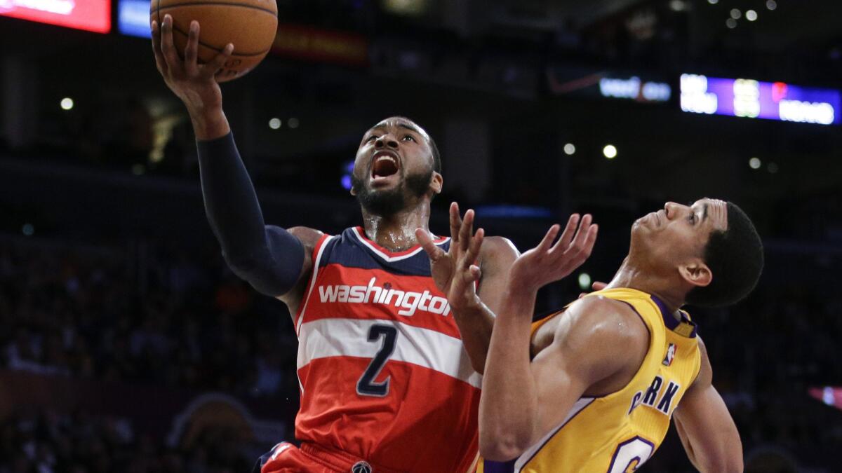 Washington Wizards guard John Wall, left, drives to the basket past Lakers guard Jordan Clarkson during the second half of the Wizards' 98-92 win Tuesday. Wall has played a key role in transforming Washington into one of the Eastern Conference's top teams.
