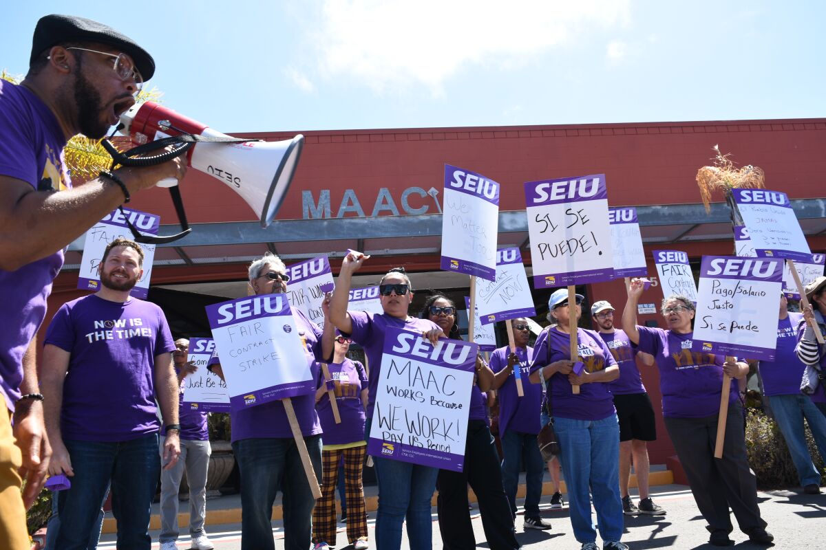 Striking MAAC employees picket outside the company's headquarters in Chula Vista on Monday.
