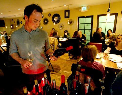 Sommelier Ryan Hess picks wine in the restaurant and wine bar on Melrose Avenue.