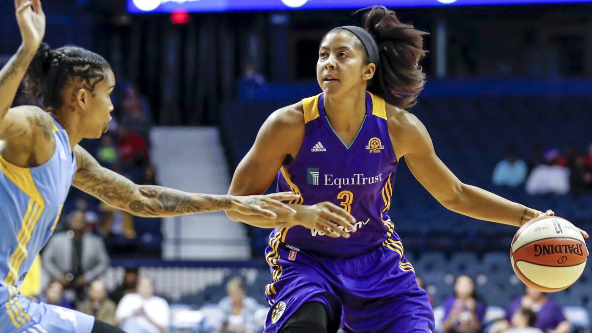 Sparks forward Candace Parker drives the lane against Sky forward Tamera Young during the first half Sunday.