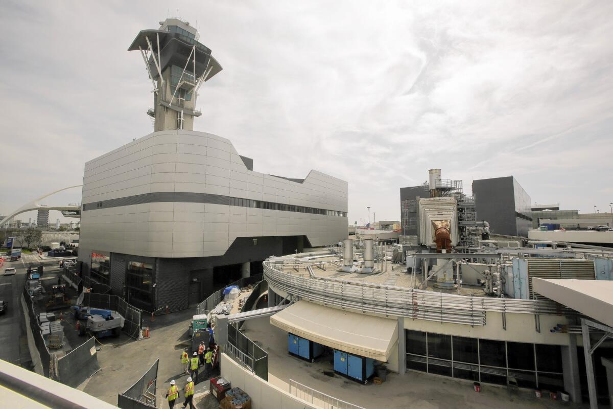 Retired plant engineers at Los Angeles International Airport have been called back to work to help current plant workers as they phase out the old heating and cooling utility and bring the new $438-million power facility, left, on line.