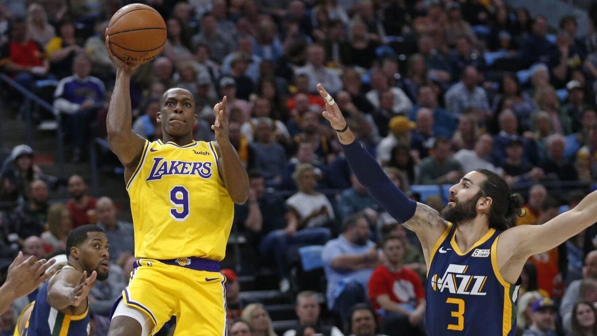 Lakers guard Rajon Rondo (9) shoots as Utah Jazz guard Ricky Rubio (3) defends during the first half on Wednesday in Salt Lake City.