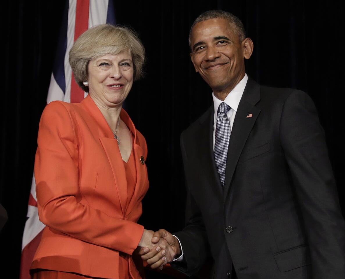 U.S. President Barack Obama and British Prime Minister Theresa May shake hands at the conclusion of a news conference after a bilateral meeting in Hangzhou in eastern China's Zhejiang province, Sunday, Sept. 4, 2016, alongside the G20.