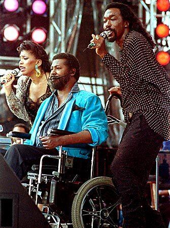Singers, from left, Valerie Simpson, Teddy Pendergrass and Nicholas Ashford perform at JFK Stadium in Philadelphia during the Live Aid famine relief concert.