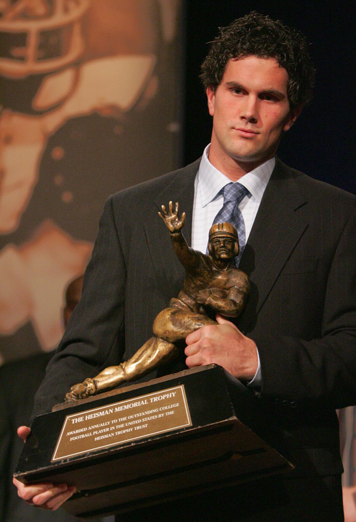 USC's Matt Leinart holds the Heisman Trophy on Dec. 11, 2004.