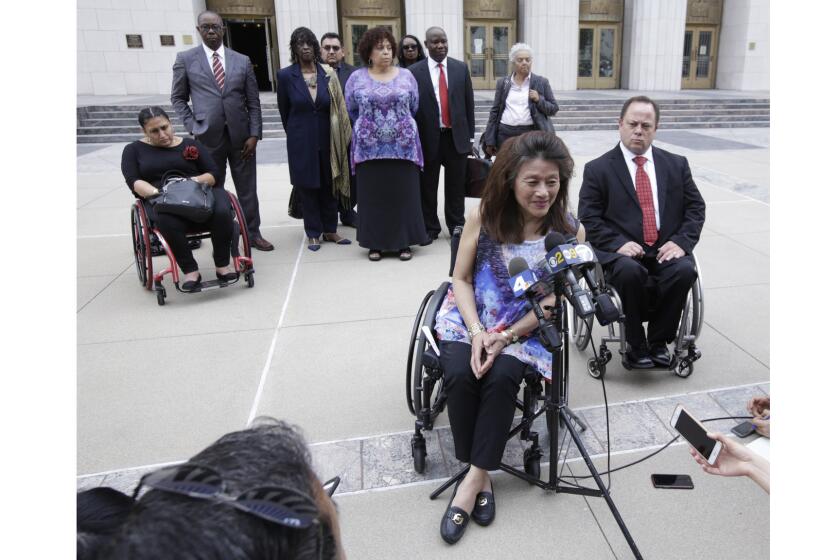 LOS ANGELES CA. JUNE 7, 2017: Whistleblower Mei Ling speaks, with her attorney Scott Moore behind her, during a media availability on June 7, 2017, outside the U.S. Courthouse in Los Angeles. The U.S. Intervened in the âÃÃ²WhistleblowerâÃÃ´ Lawsuit against City of Los Angeles that Alleges City Received Millions of Dollars in Federal Grants and knowingly failed to Provide Housing Accessible to the Disabled. (Glenn Koenig/ Los Angeles Times)