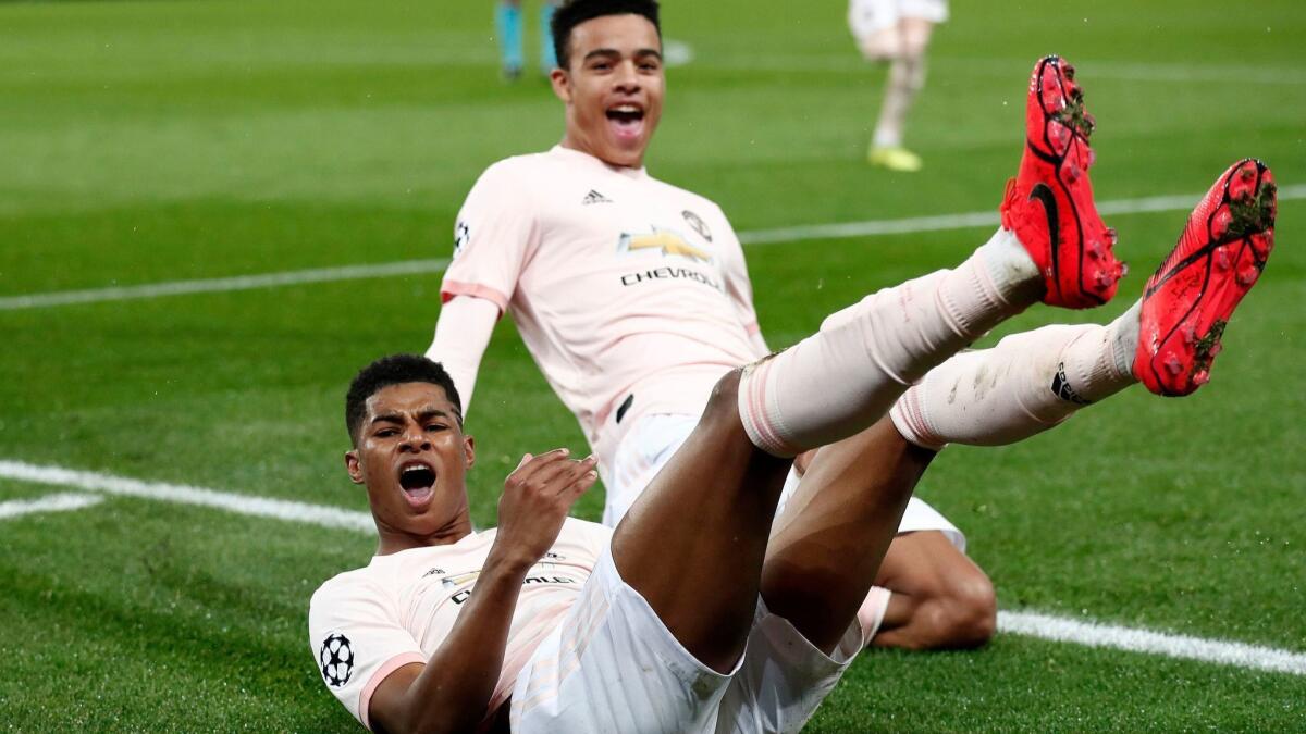 Manchester United's Marcus Rashford, left, and Mason Greenwood celebrate taking a 3-1 lead over Paris Saint-Germain during Champions League play Wednesday.