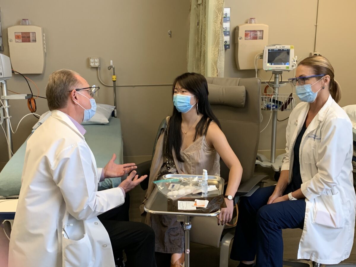 Dr. Philip Robinson, left, explains the process to Chen Cao.