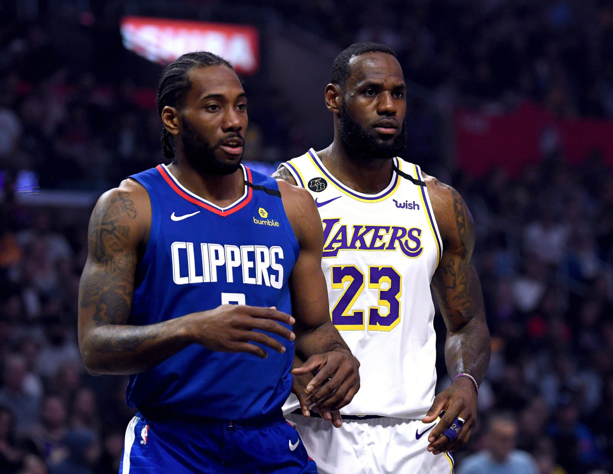 Clippers forward Kawhi Leonard and Lakers forward LeBron James stand next to one another during a game in March.