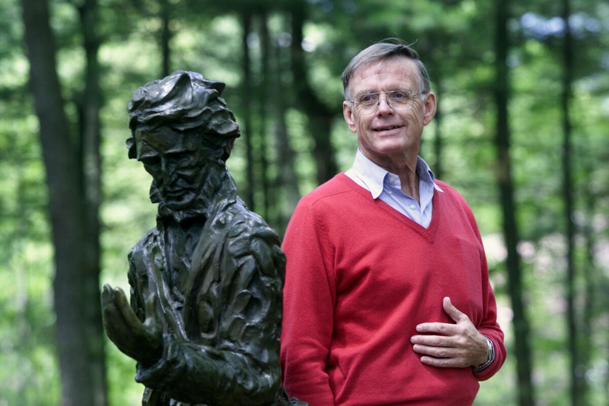 Author Robert D. Richardson stands by the statue of Henry David Thoreau at the Walden Pond Reservation.