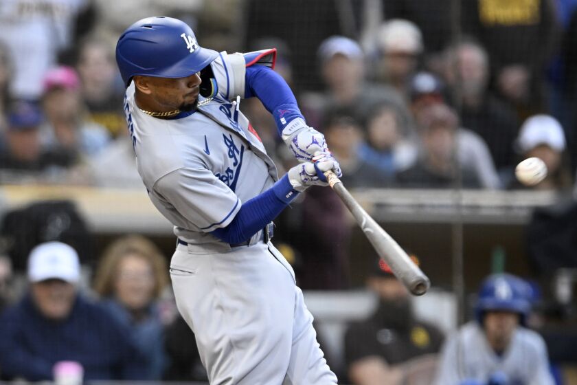 Los Angeles Dodgers' Mookie Betts hits a solo home run against the San Diego Padres.