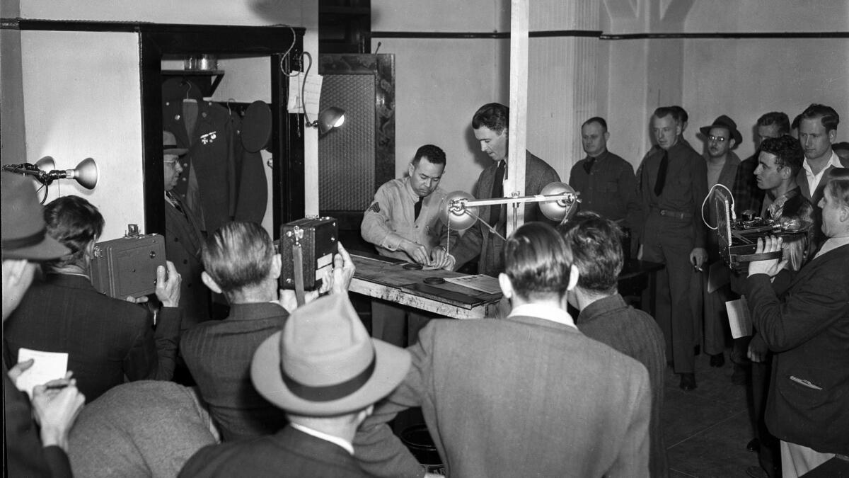 Mar. 22, 1941: Actor Jimmy Stewart being finger printed for induction into the United States Army.