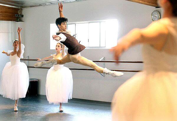 Chehon Wespi-Tschopp, center, leaps during a rehearsal of "Giselle" with fellow dancers at Los Angeles Ballet.