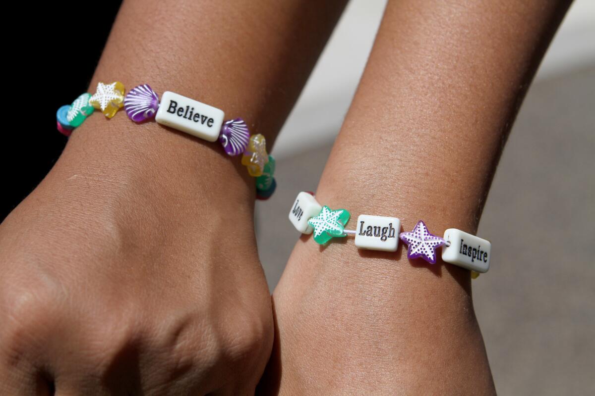Camp counselor Esmee Hernandez, left, and Ari Allen, 13, show off the friendship bracelets they made at the annual Summer Daze camp at Johnny Carson Park in Burbank on Thursday, Aug. 11, 2016.