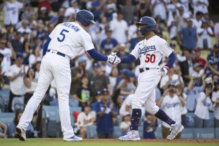 Dodgers' Mookie Betts celebrates with Freddie Freeman after hitting a home run on July 8, 2023, against the Angels.