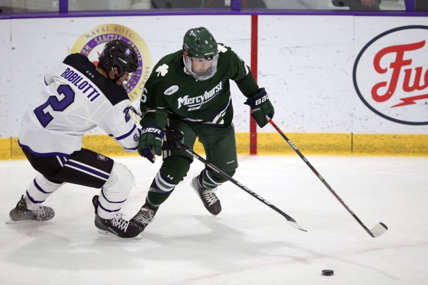 FILE - Holy Cross's Jack Robilotti (2) defends Mercyhurst's Carson Briere (6) during the first half of an NCAA hockey game on Friday, Nov. 12, 2021, in Worcester, Mass. The son of Philadelphia Flyers interim general manager Danny Briere has apologized after a video posted on social media showed him pushing an empty wheelchair down a set of stairs. Mercyhurst University hockey player Carson Briere issued his apology in a statement released by the NHL’s Flyers on Wednesday, March 15, 2023. (AP Photo/Stew Milne, File)