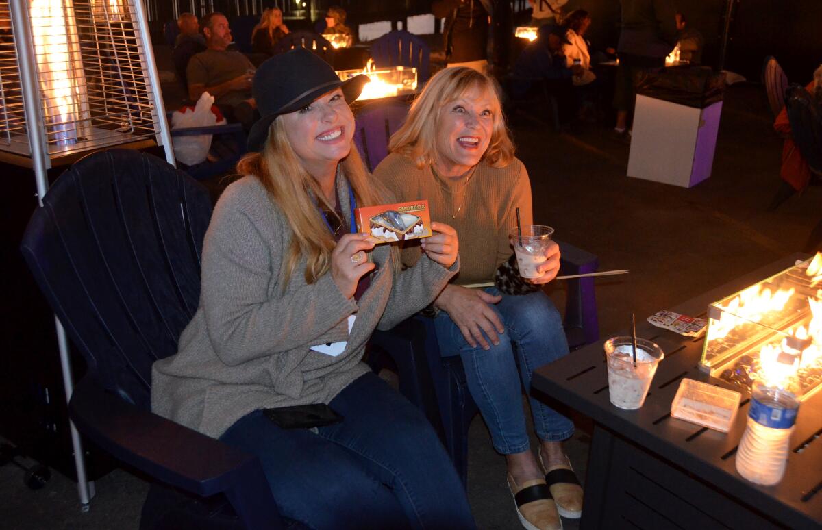 Kristie Hensley holds the "S'mores kit" to be toasted over the portable fire pit.