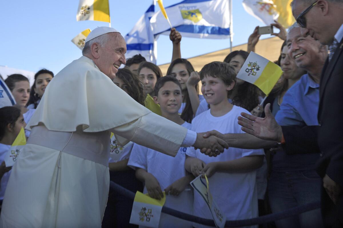 Pope Francis greets Israeli children after arriving at the heliport of Hadassah hospital in Jerusalem on Sunday.