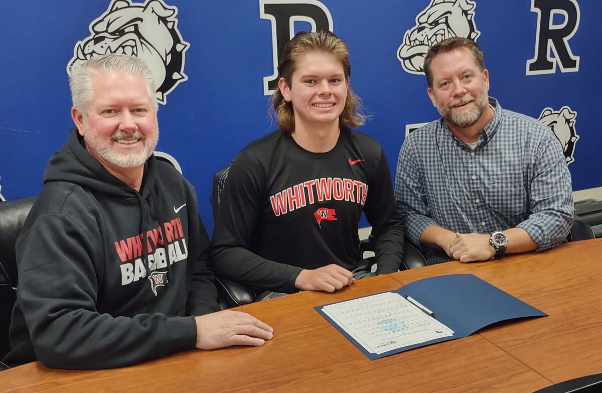 Baseball player Reed Gunnett, 17, headed to Whitworth University is with his dad, Chris Gunnett, left, and Coach Dean Welch.