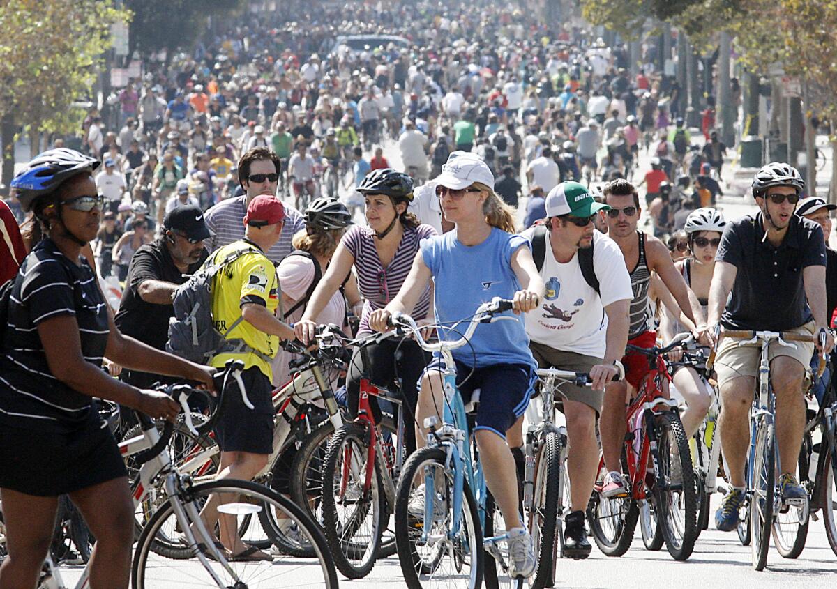 Thousands of bicyclists pedal up and down Spring Street in downtown Los Angeles during CicLAvia last year.