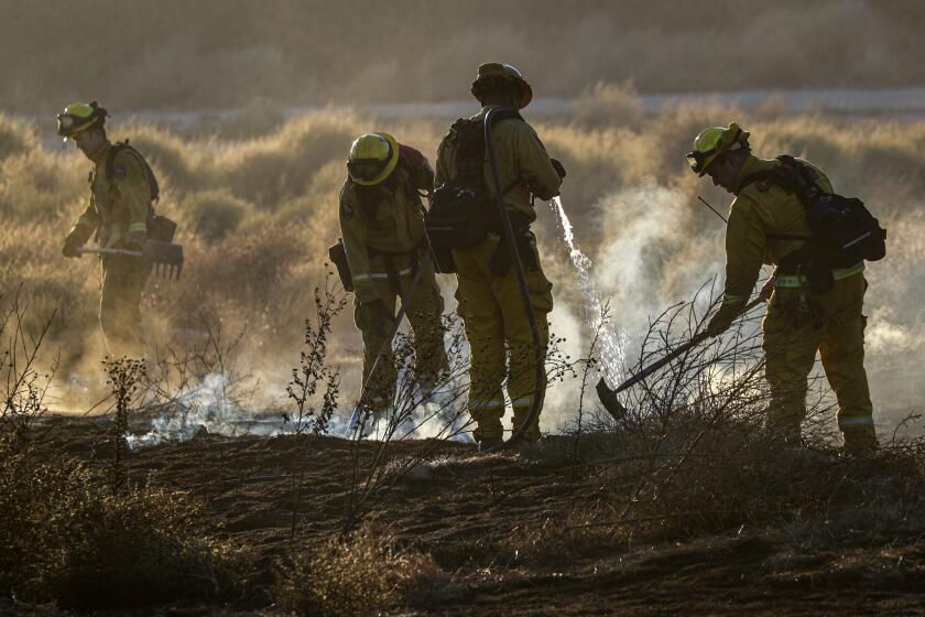 RIVERSIDE CA OCTOBER 31, 2019 -- Helicopters make water drop on a wind-driven brush fire dubbed the 46 fire in Jurupa Valley Thursday October 31, 2019 in Riverside. (Irfan Khan / Los Angeles Times)