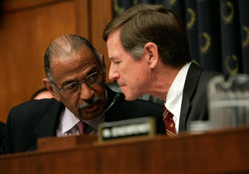 Rep. Lamar Smith (R-Tex.), right, seen here with Rep. John Conyers (D-Mich.), has been challenging NSF grant decisions.