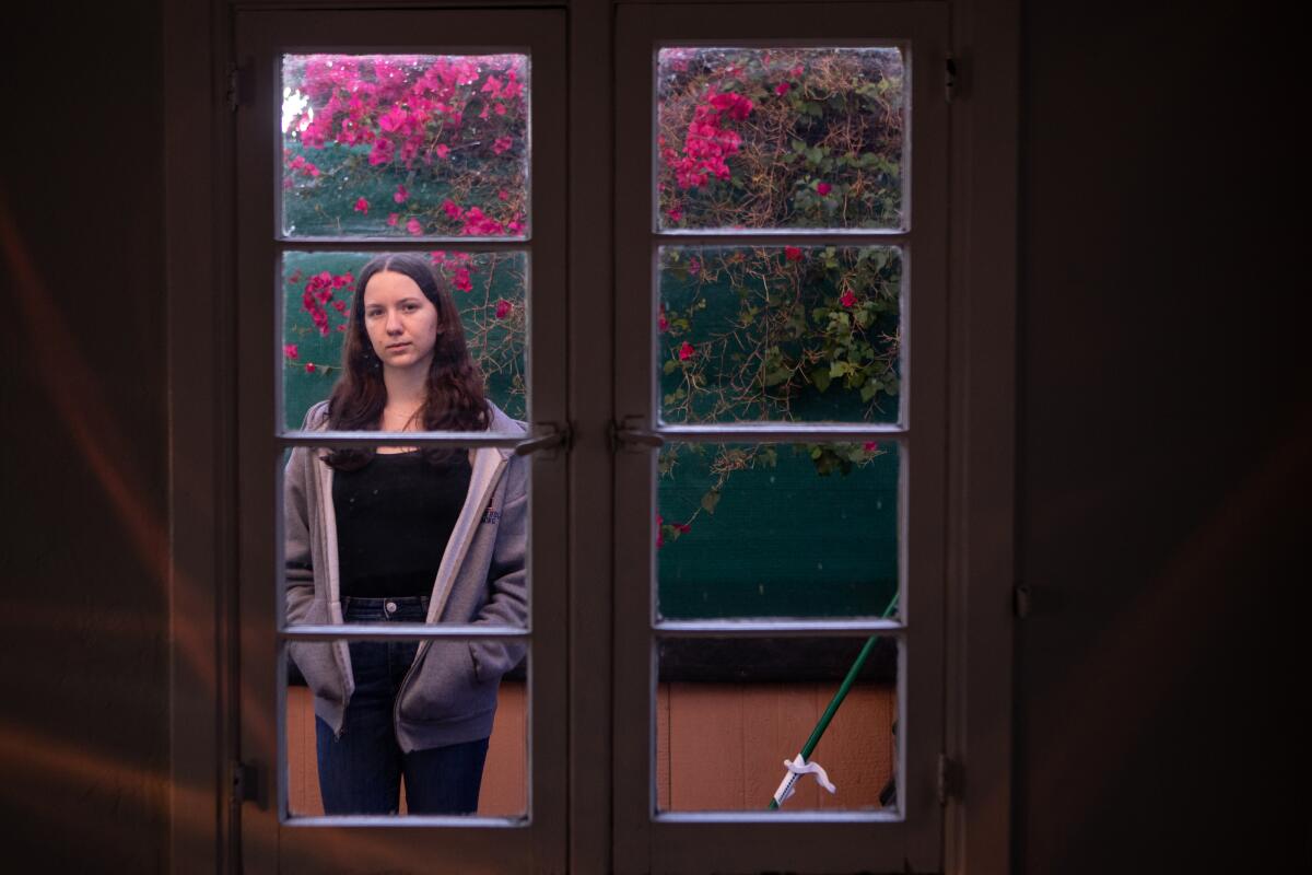 Grace Campbell-McGuire stands on the patio where a robber entered her home in Los Angeles.