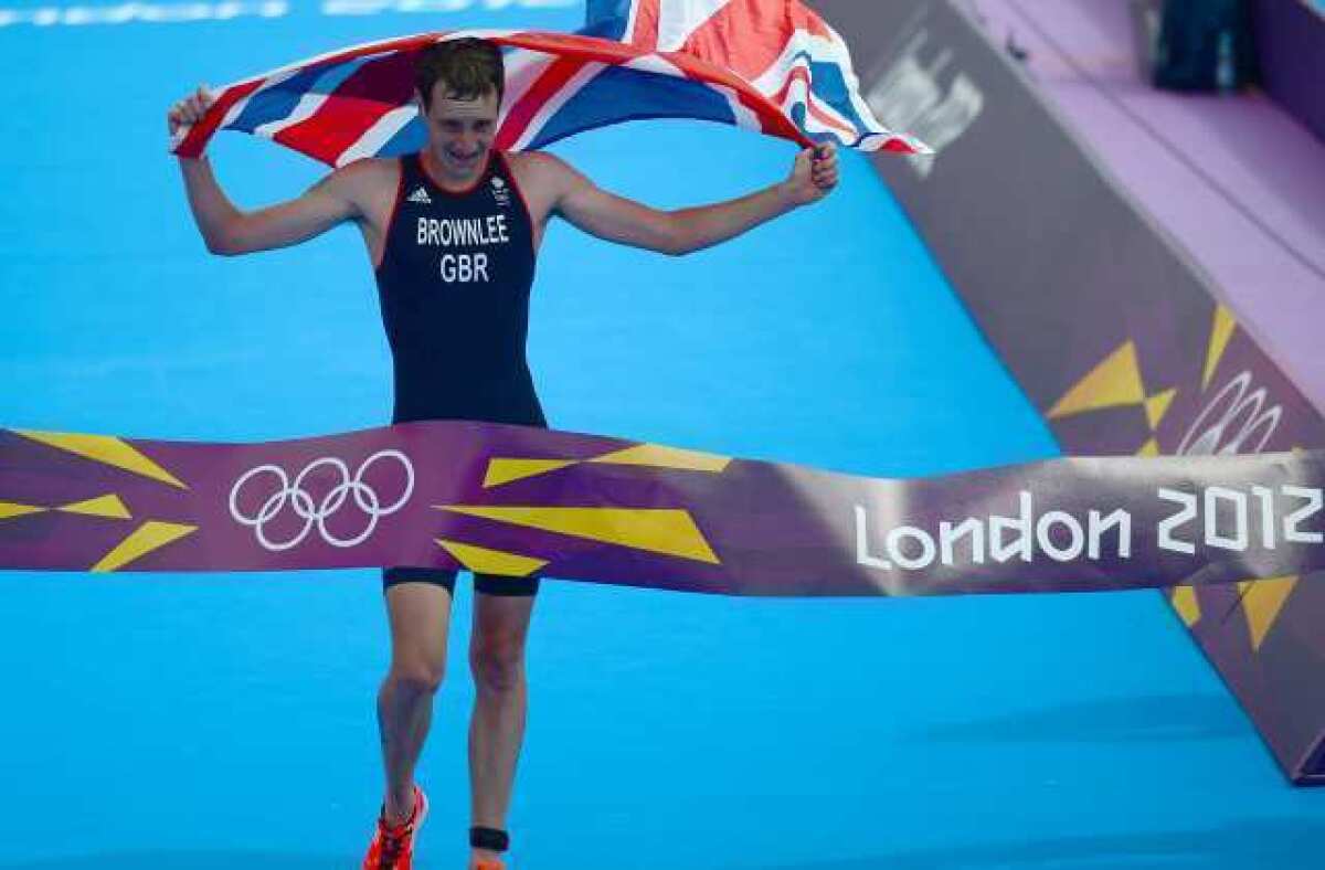 Alistair Brownlee of Britain crosses the finish line to take the gold medal in the men's triathlon.
