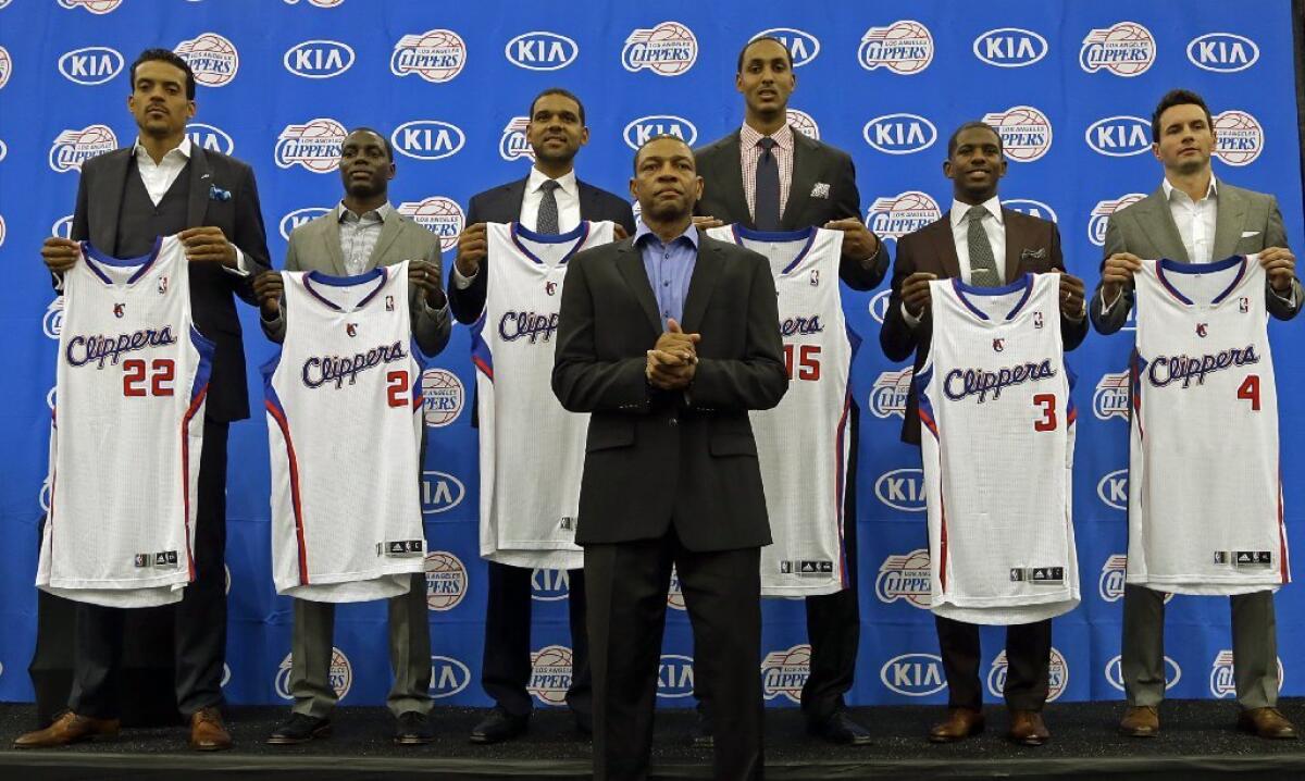 New Coach Doc Rivers stands front and center with Clippers players who have been either re-signed or acquired during the off-season: Matt Barnes, from left, Darren Collison, Jared Dudley, Ryan Hollins, Chris Paul and J.J. Redick.