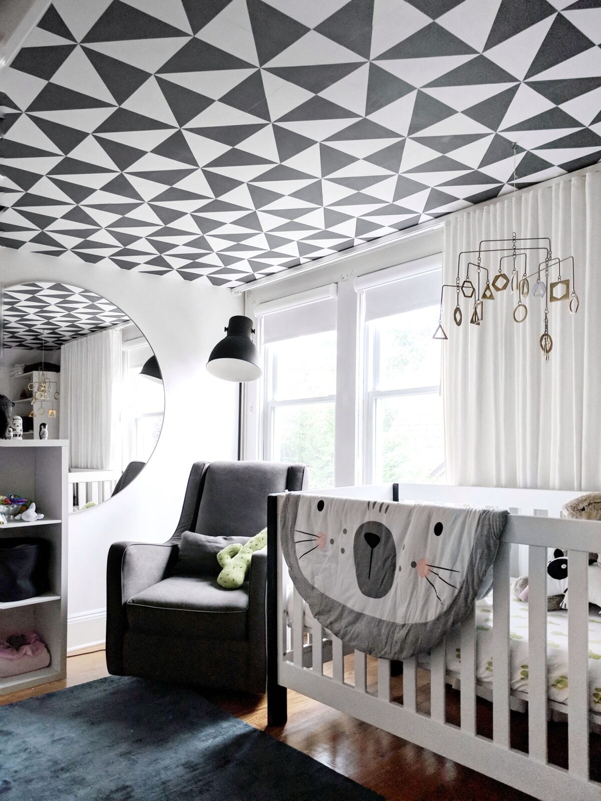Designer Crystal Sinclair used graphic wallpaper by Chasing Paper on a nursery ceiling.