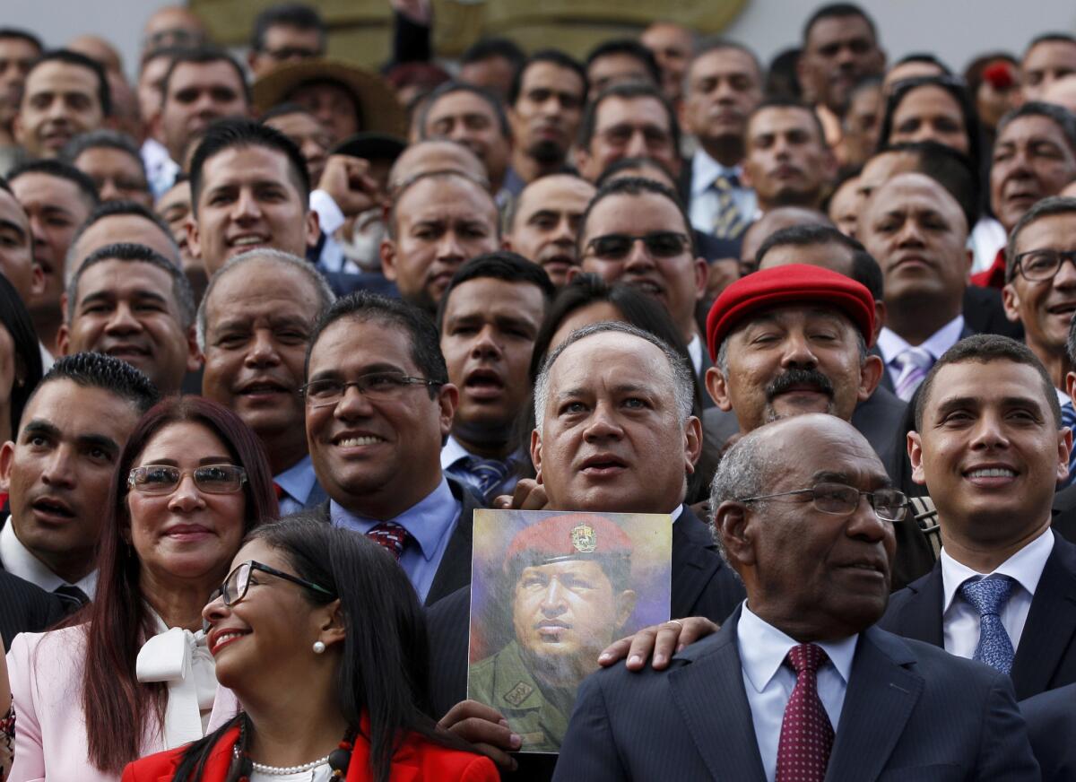 Venezeula's first lady, Cilia Flores, second row left, takes her place with members of the constitutional assembly for an official photo in Caracas on Aug. 4, 2017.
